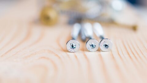 Assorted Torx head screws and fasteners laid out on a work surface