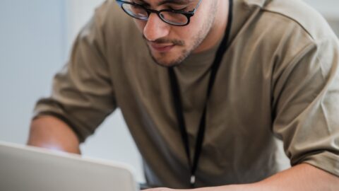 Man in eyeglasses working on a laptop