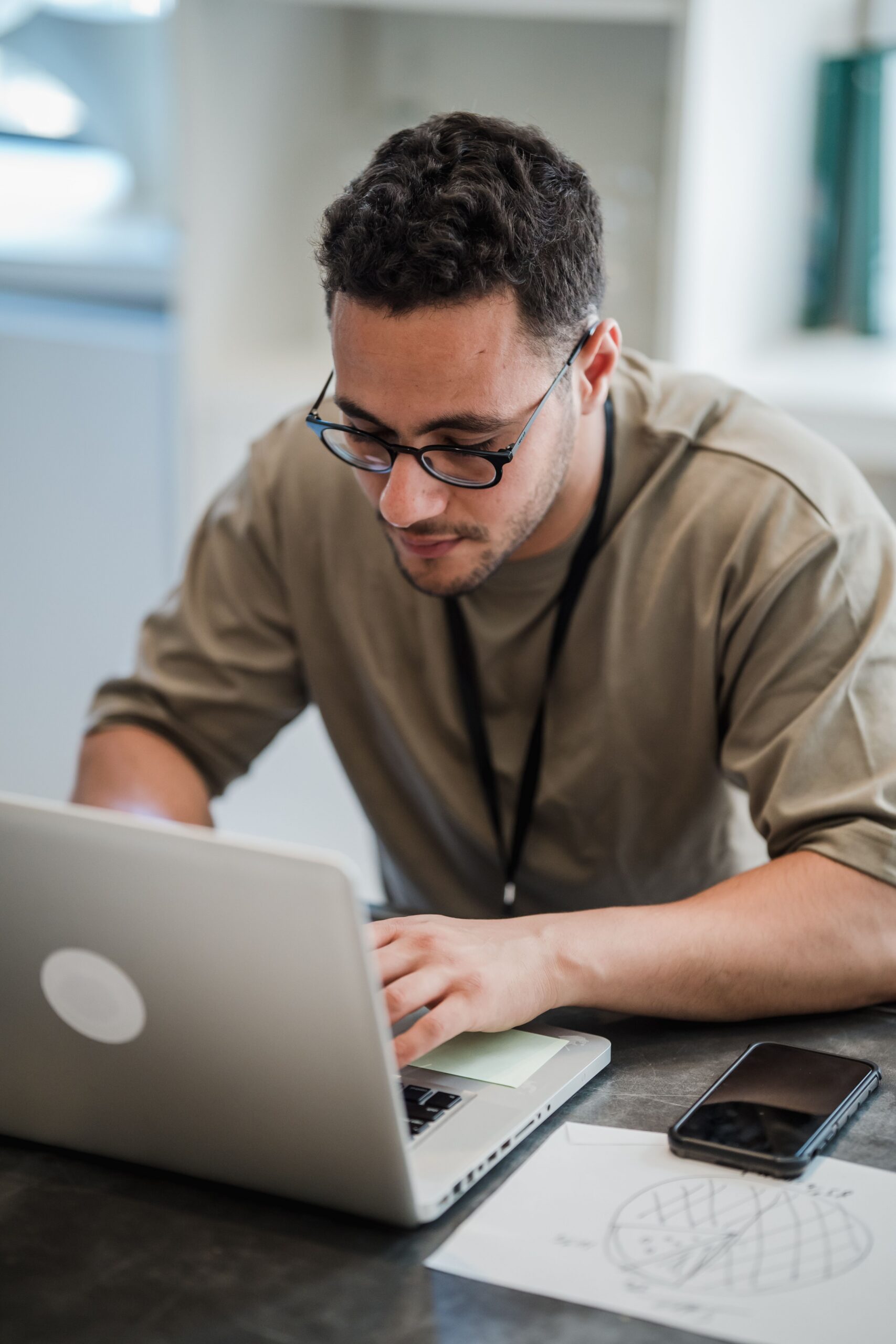 Man in eyeglasses working on a laptop